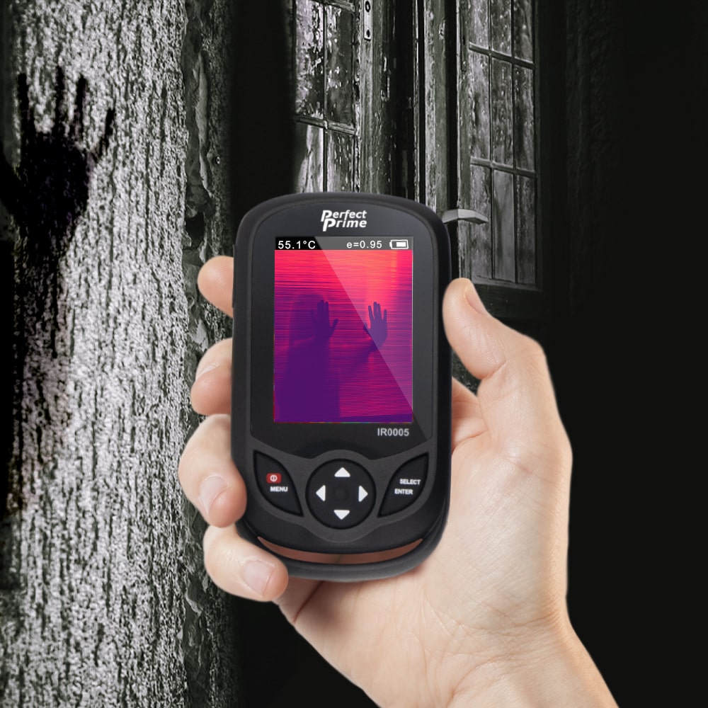 hand holding a thermal camera in dark scary wood